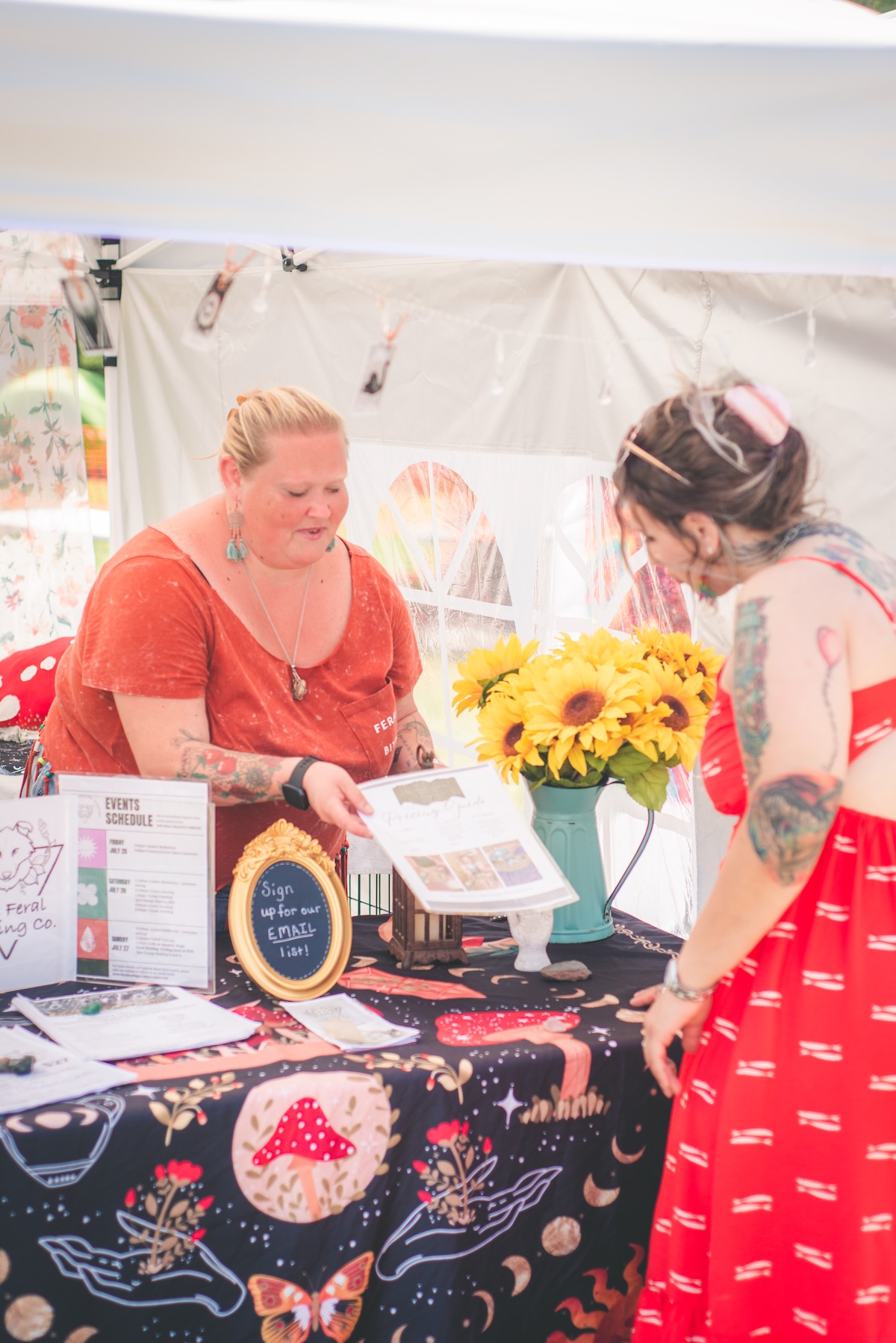 woman greets a customer at her tent