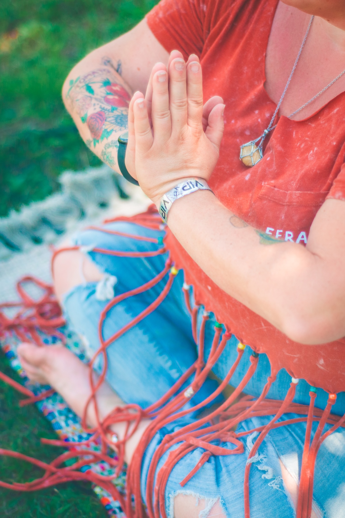womans hands pressed together in meditation