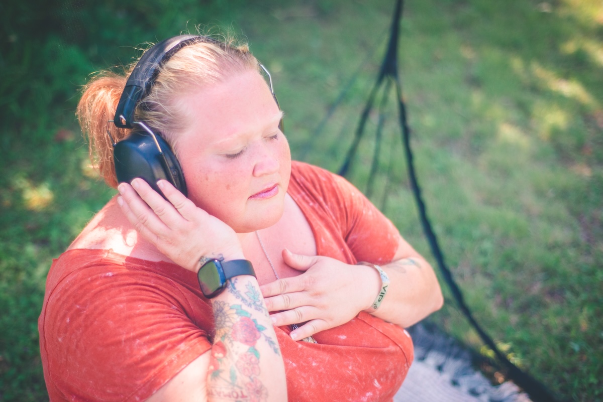 woman does breathing meditation in a mesh tent