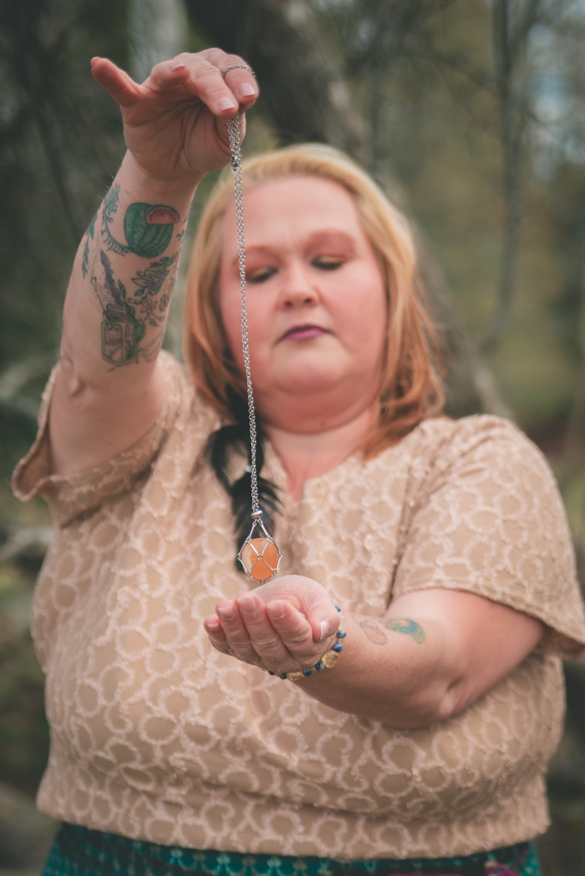 woman holds crystal necklace over her palm