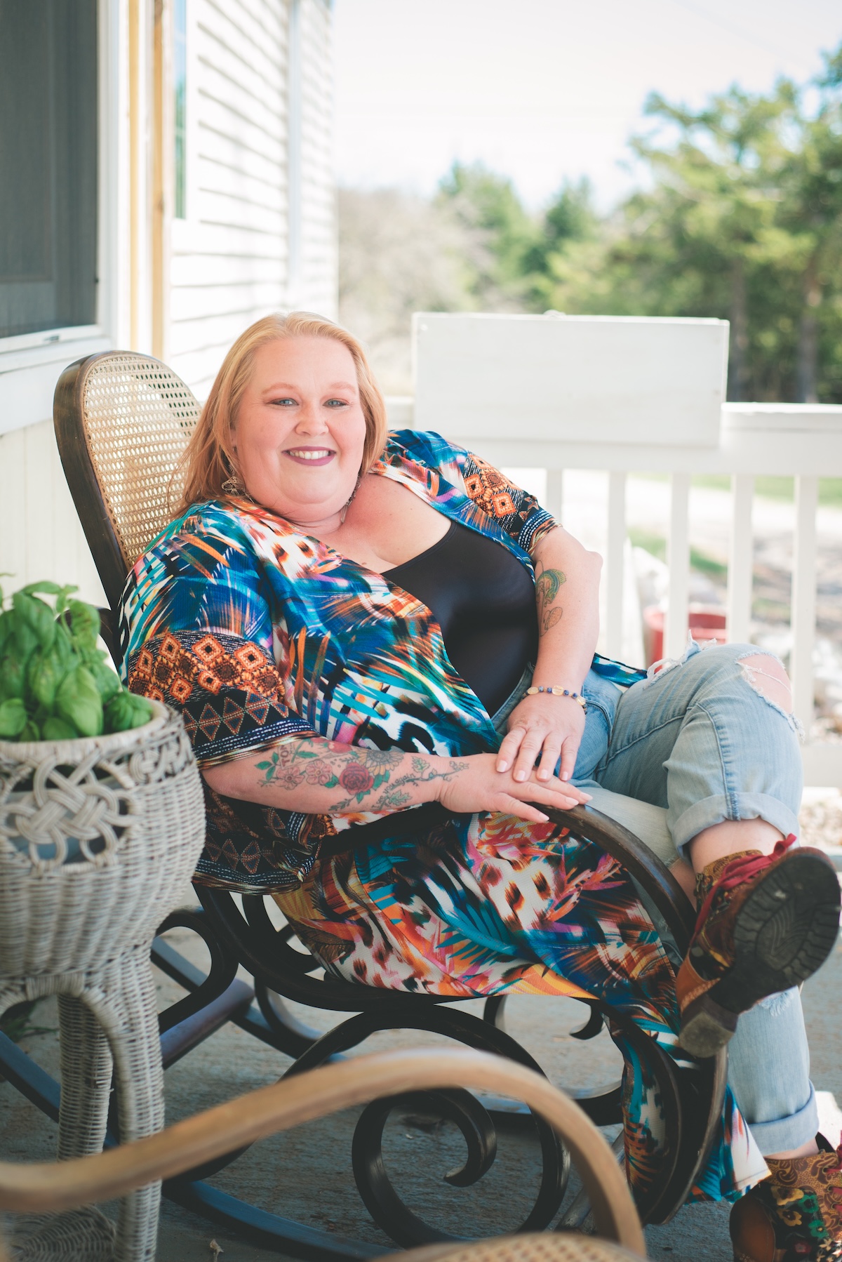 reiki healer sits in chair on porch