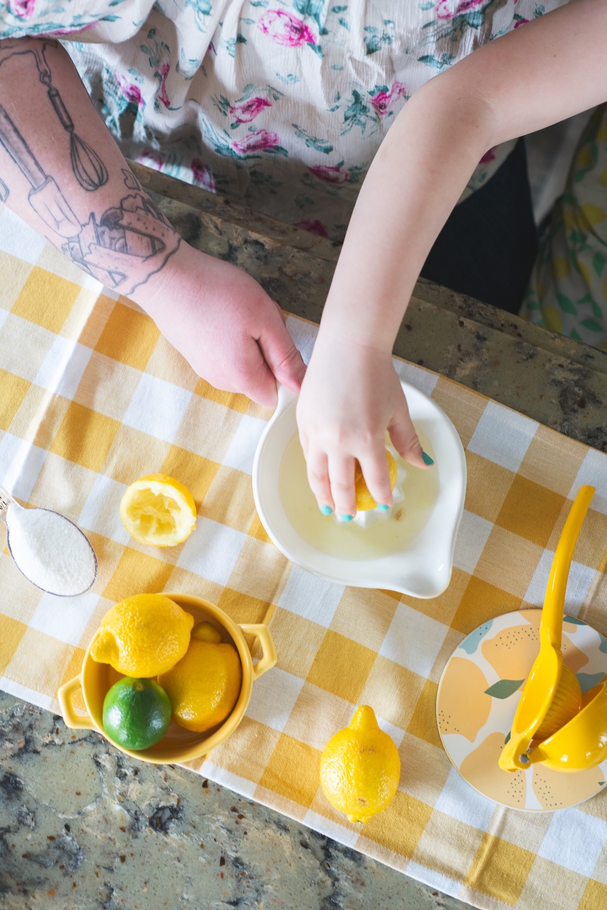 hands pressing lemons to make lemonade