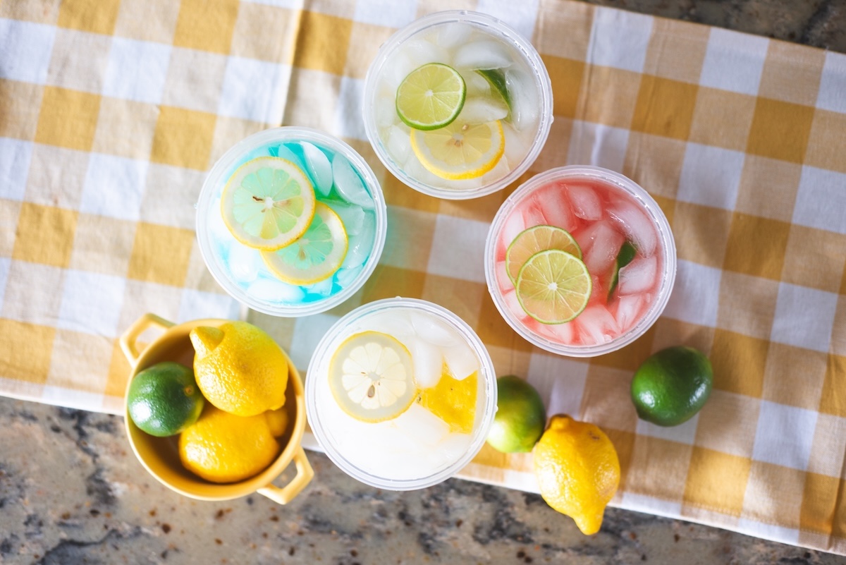 overhead photo of cups of colorful lemonade