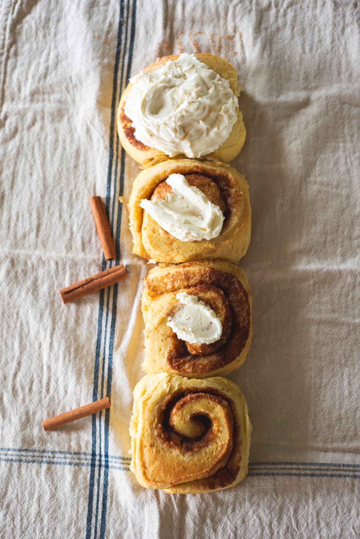 product photo of home made cinnamon rolls on a tea towel