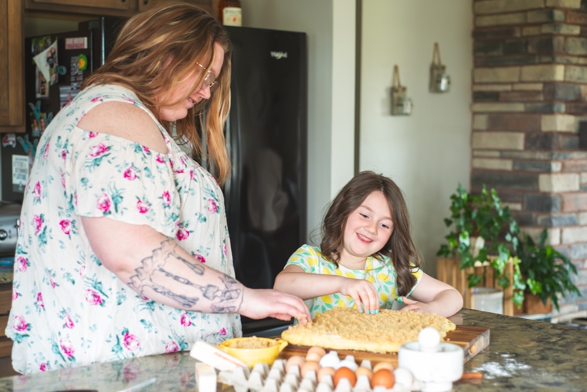mom and daughter making cinnamon rolls together