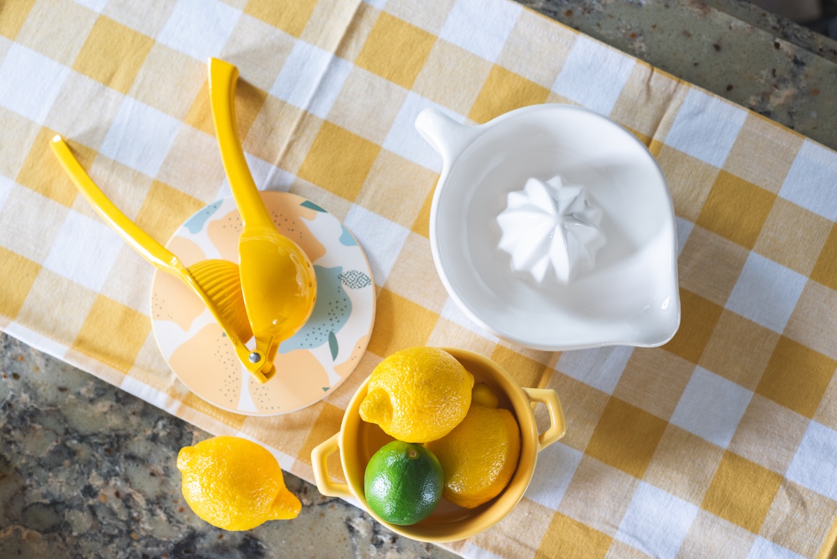 lemonade squeezer and lemons on a table top