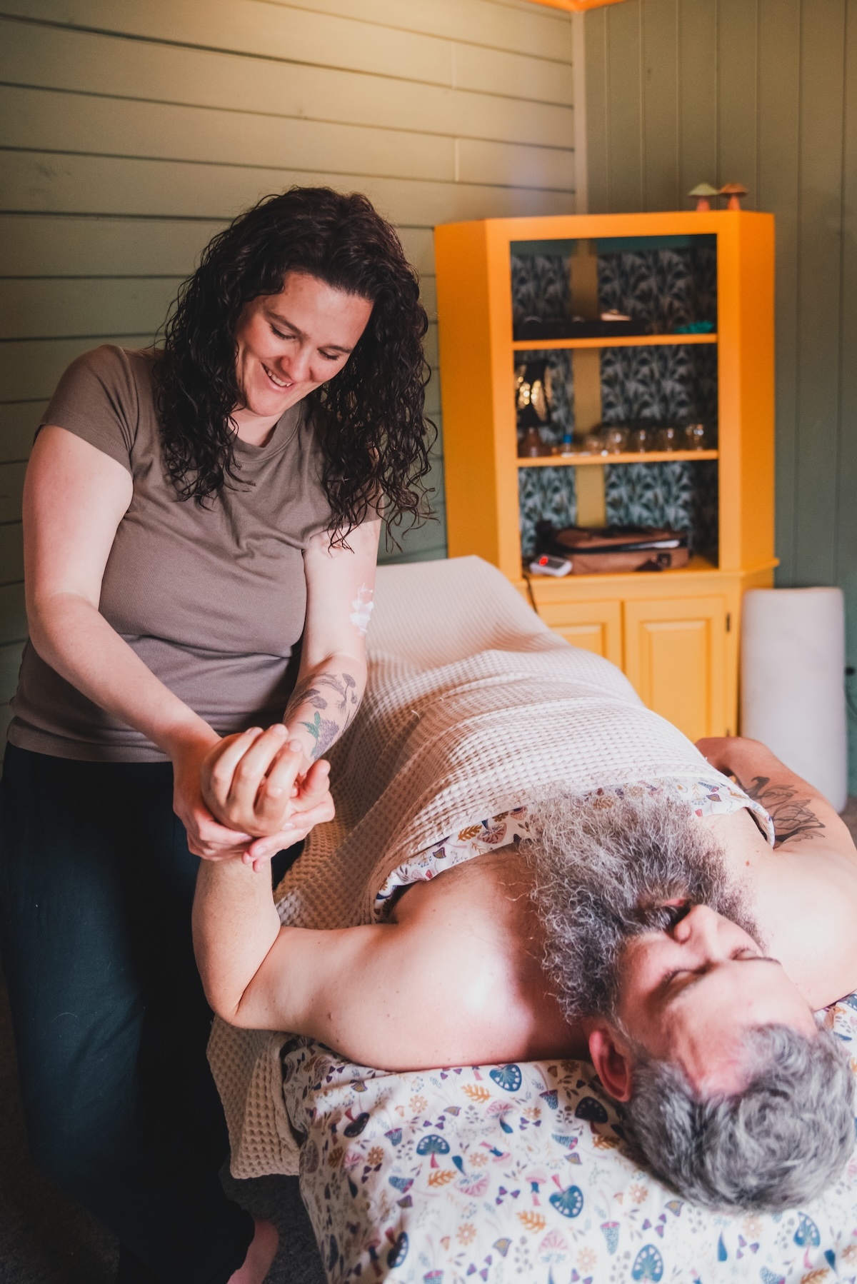massage therapist massages a man's hand