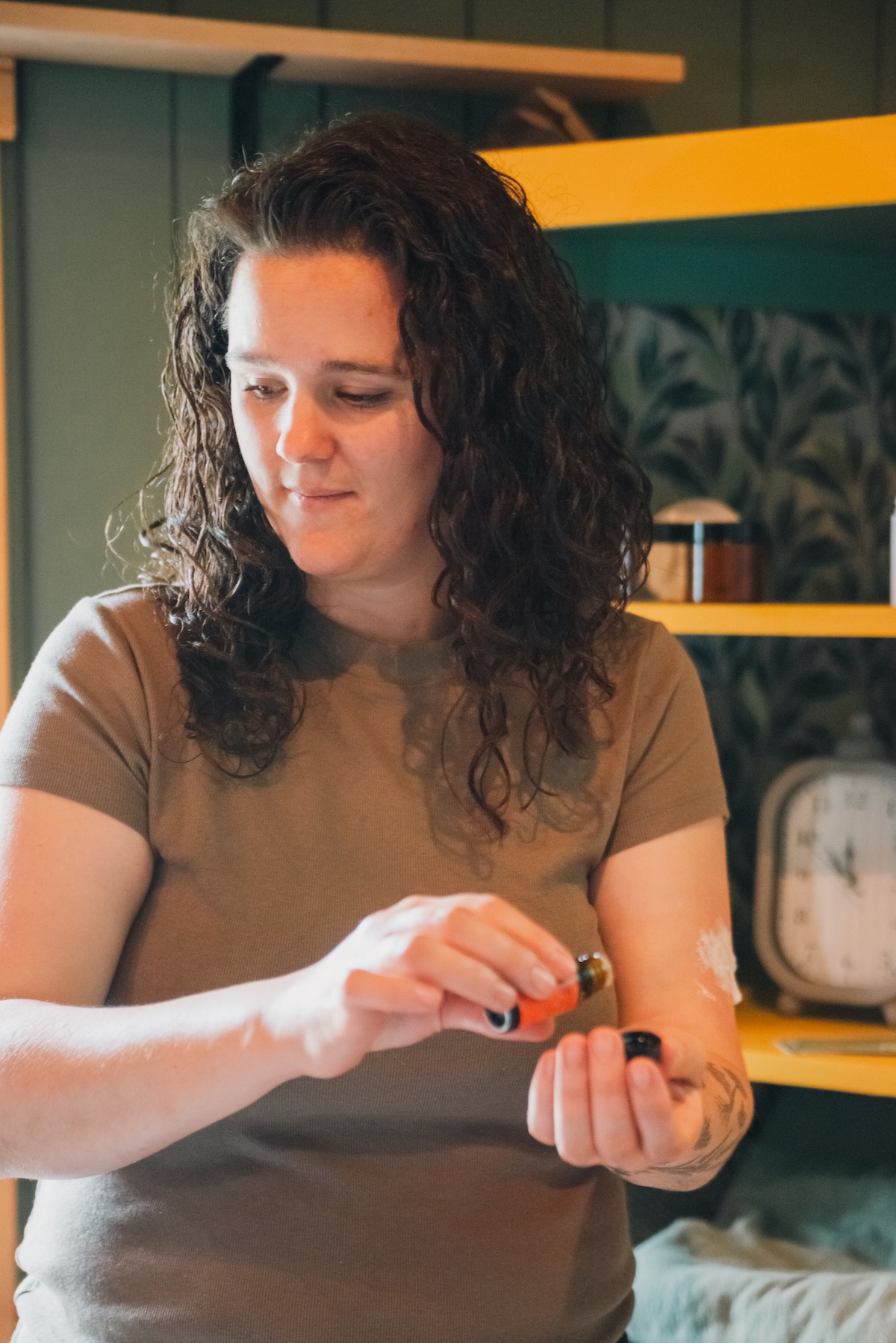 massage therapist puts essential oils into her hand