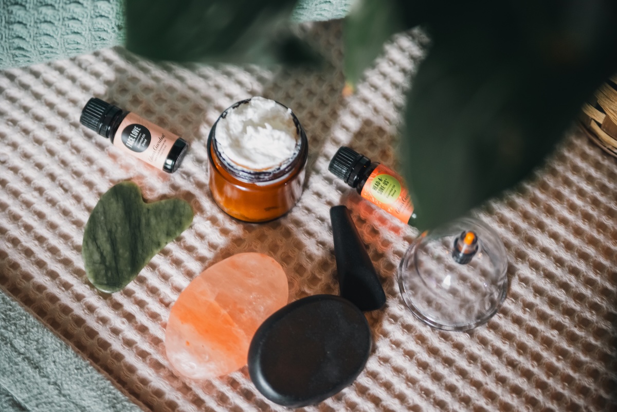 massage therapist flat lay of oils and creams and stones
