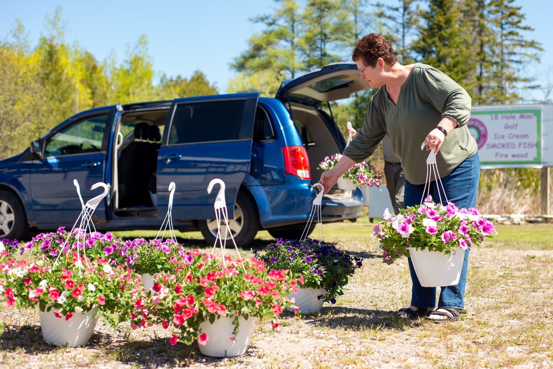 Customers shopping for spring hanging flower baskets to decorate UP camps during the Andruk Acres flower pop up event