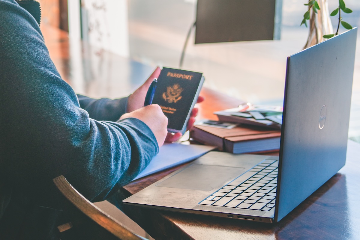 travel agent hands working while holding passport