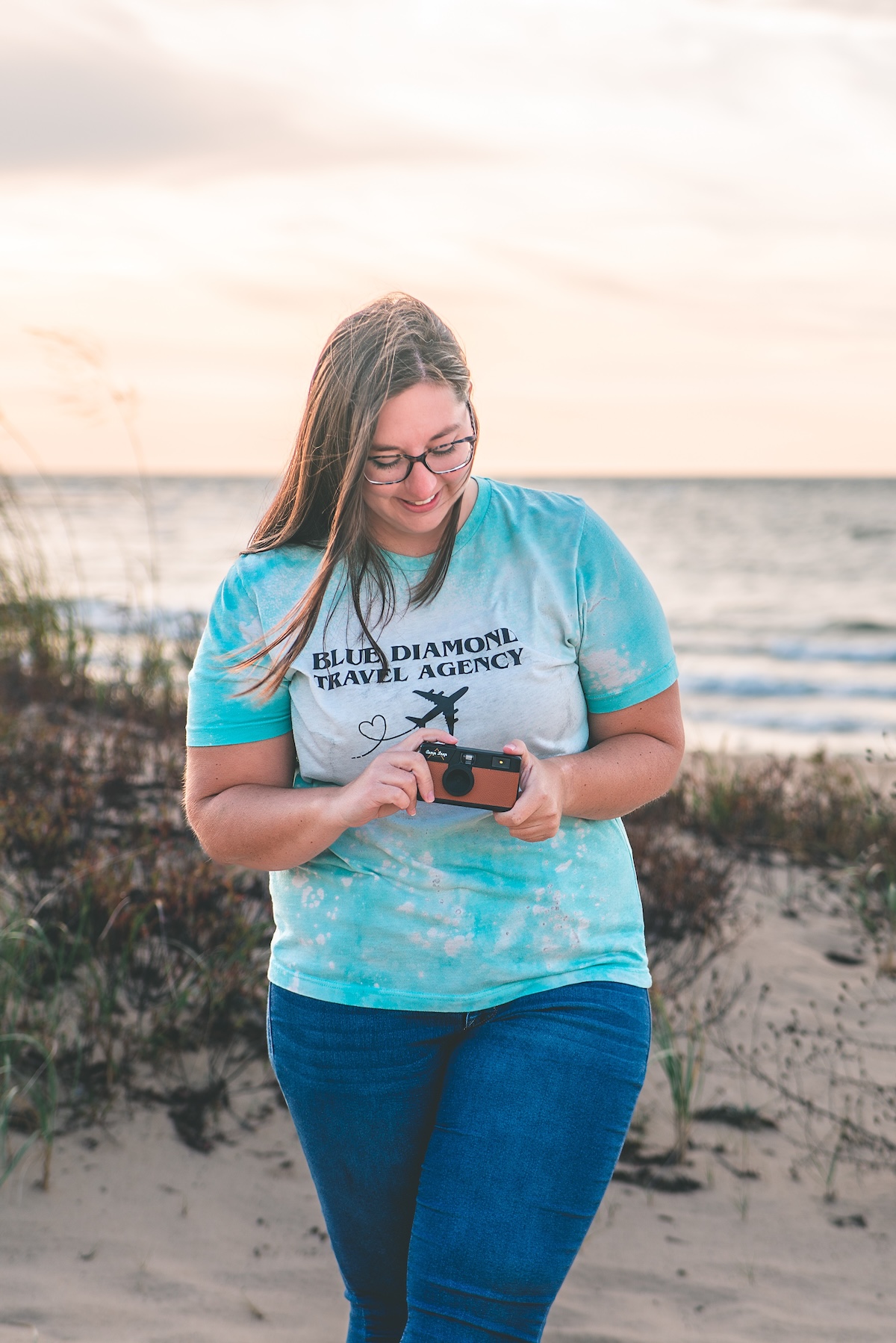 travel agent holds camera on the beach