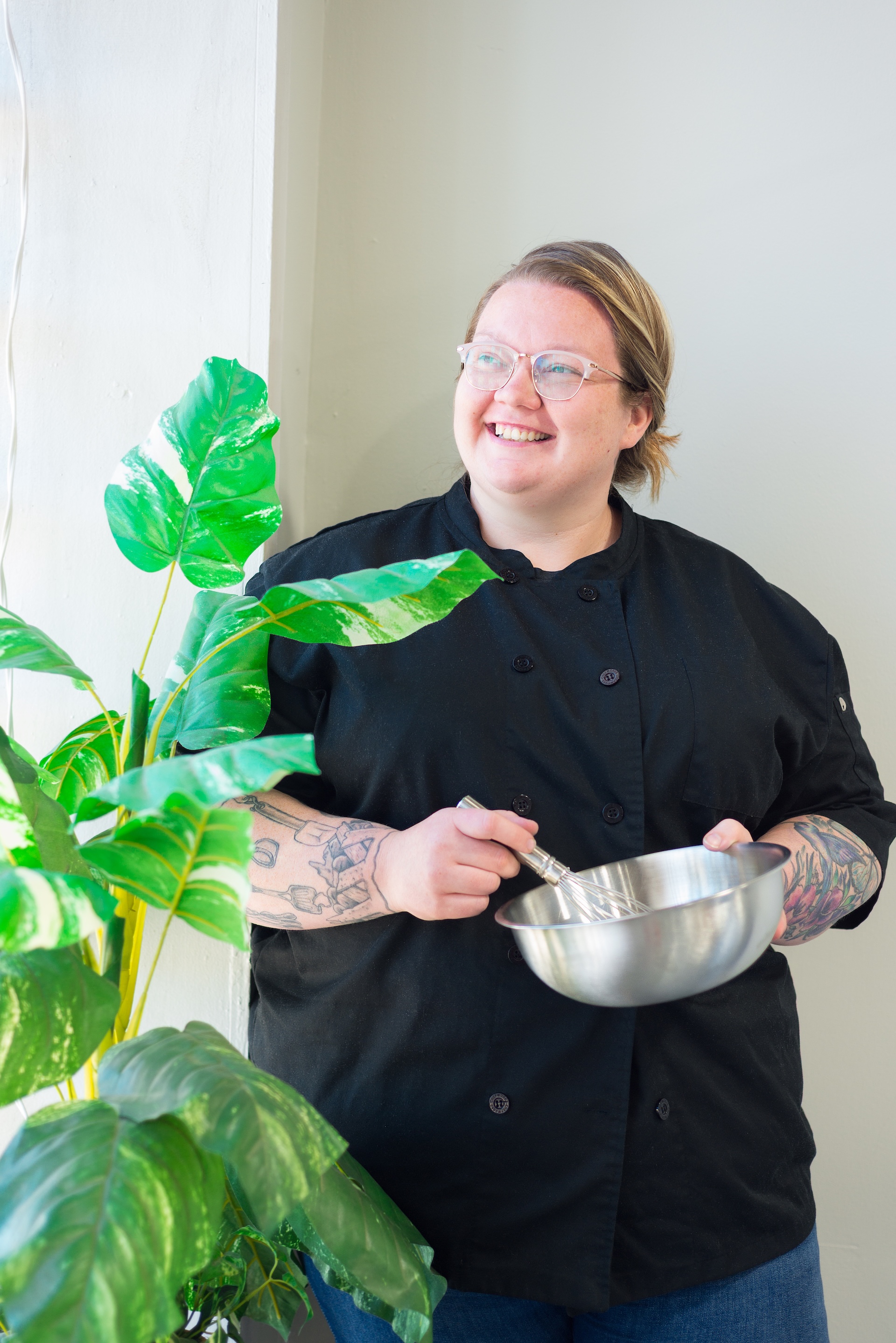 Brianna from The Cake Lady & Co wisks a cake and looks off camera