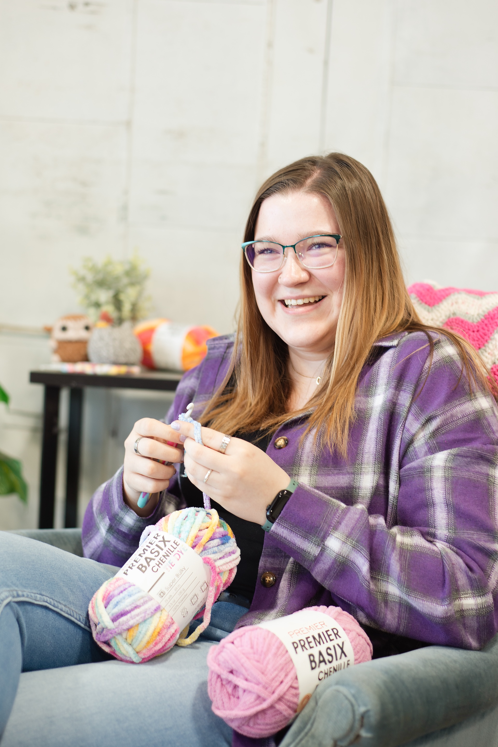 Courtney laughs while crocheting