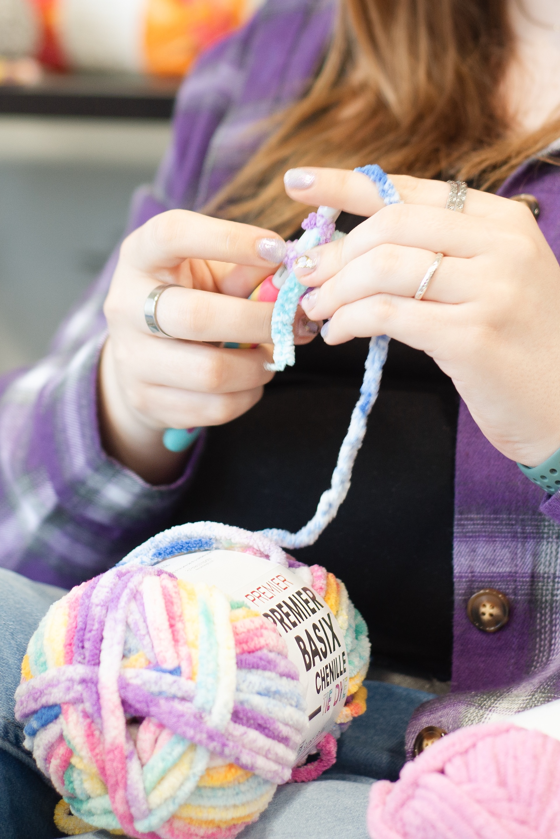 close up of hands crocheting