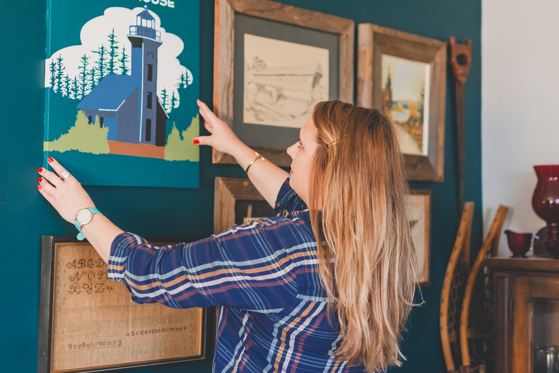 Jamie of Starsiding Studio hangs her custom vintage art in her Munising MI art studio