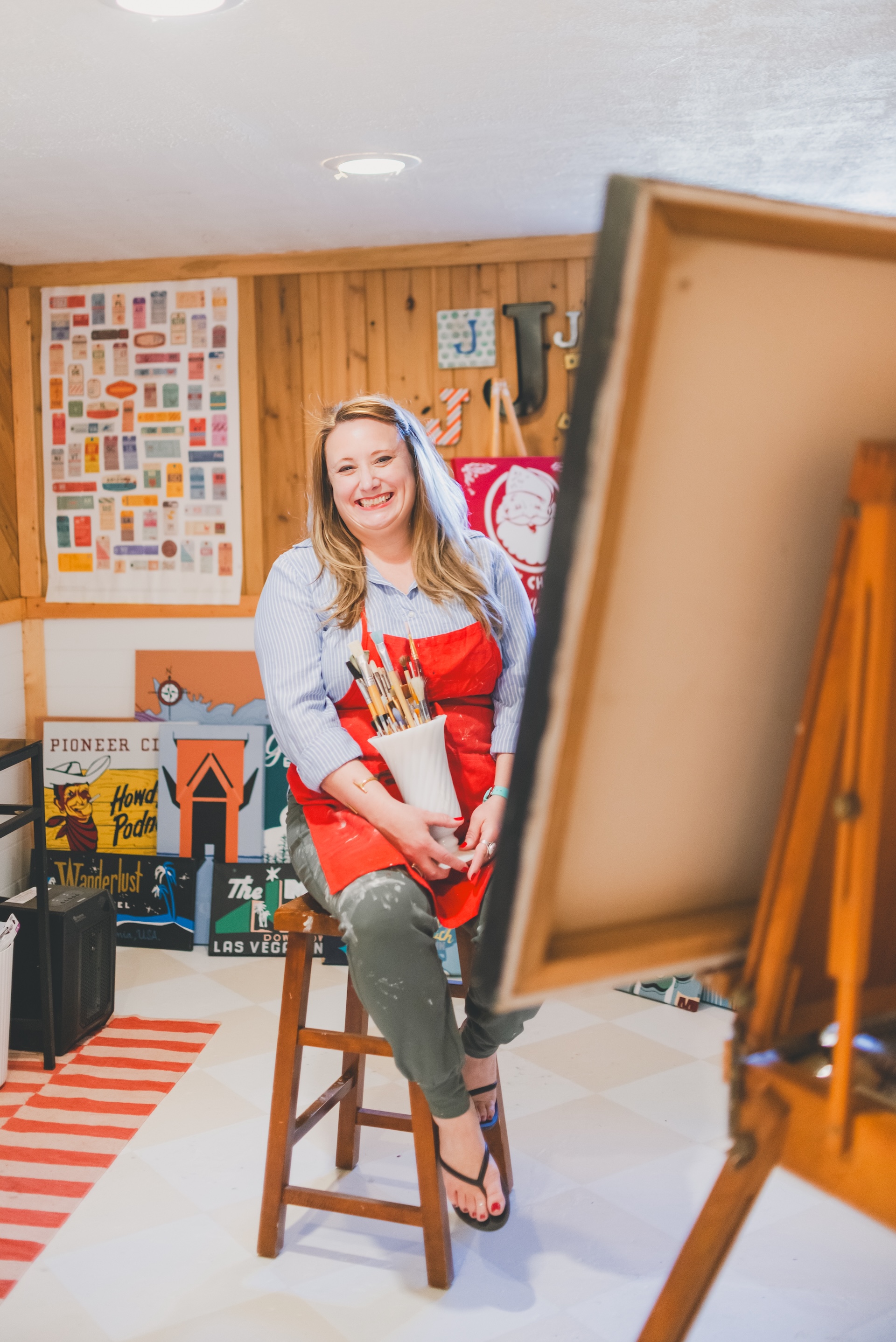 Jamie of Starsiding Studio painting custom vintage works in her Munising MI art studio