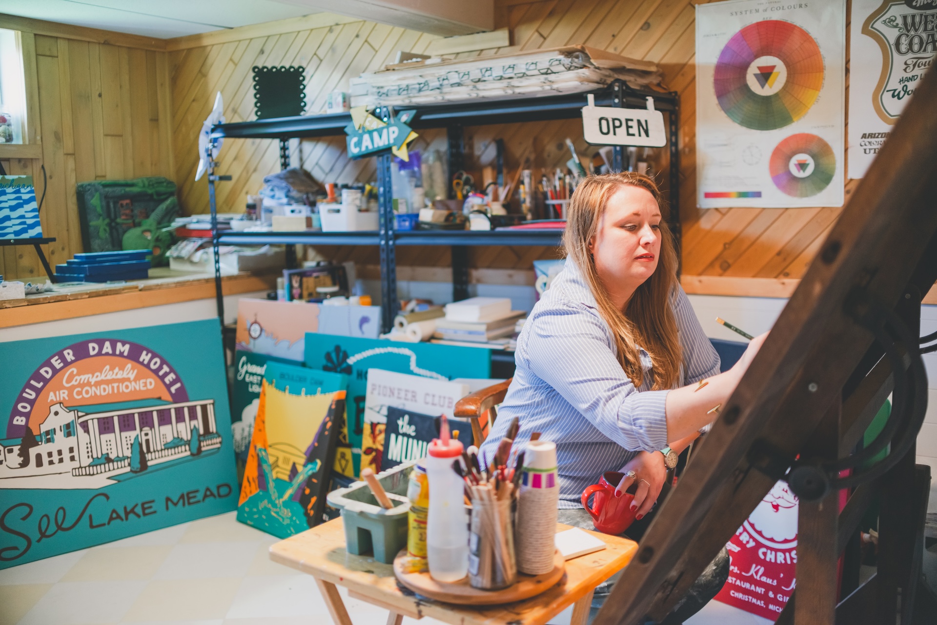 Jamie of Starsiding Studio painting custom vintage works in her Munising MI art studio