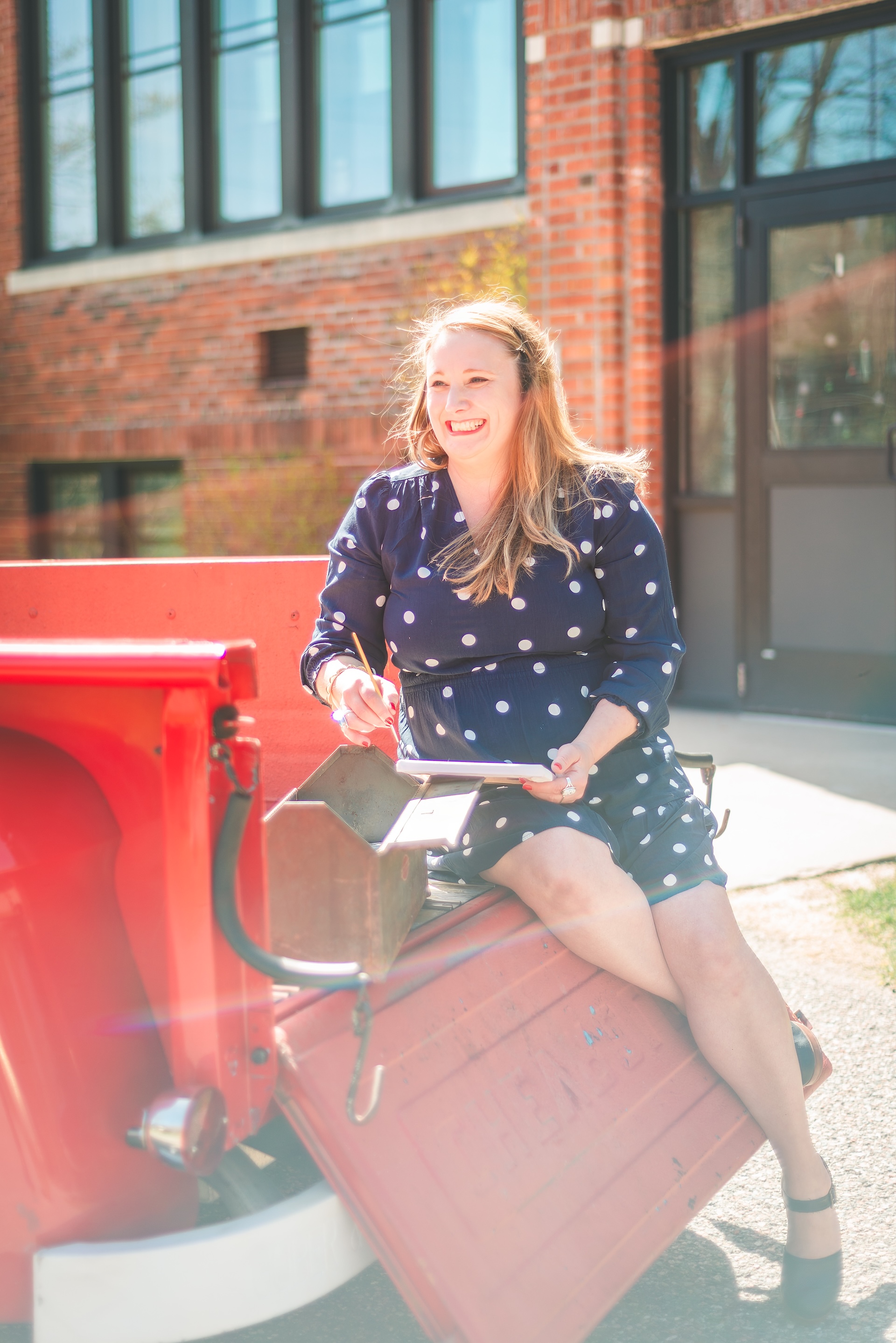 Michigan muralist Jamie posing with her vintage 1964 Chevy truck during a UP lifestyle branding photoshoot