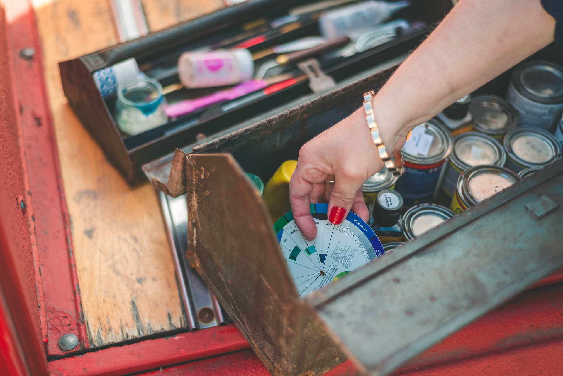 Close up of of paintbrushes, art supplies, and vintage red truck during a personal branding session