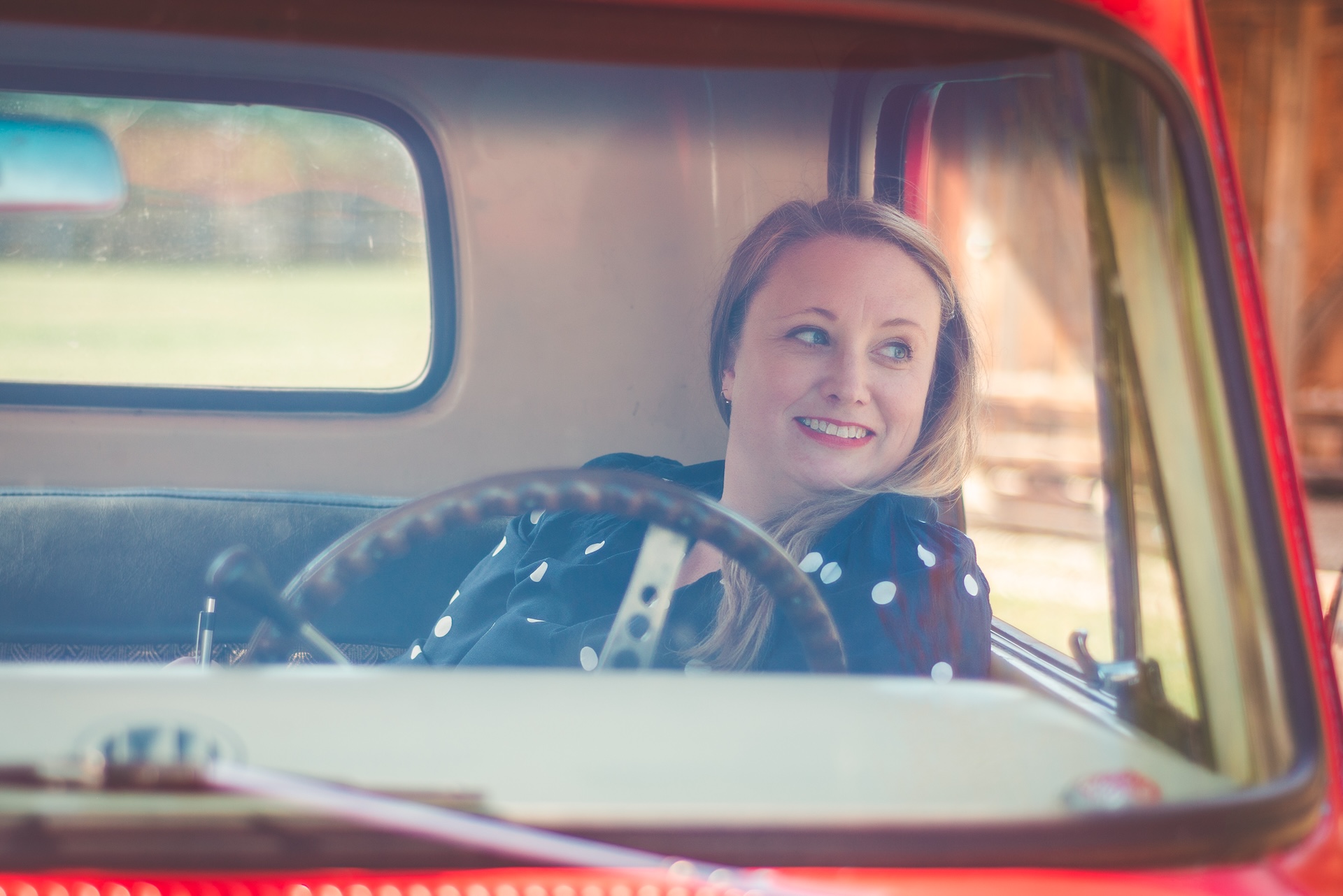 Michigan muralist Jamie posing with her vintage 1964 Chevy truck during a UP lifestyle branding photoshoot