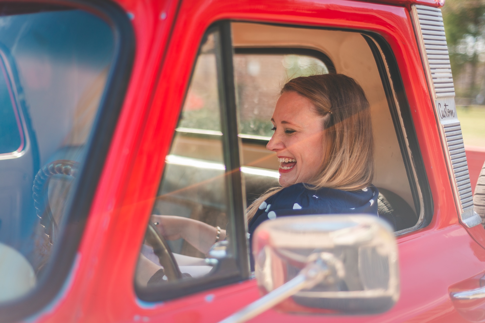 Michigan muralist Jamie posing with her vintage 1964 Chevy truck during a UP lifestyle branding photoshoot