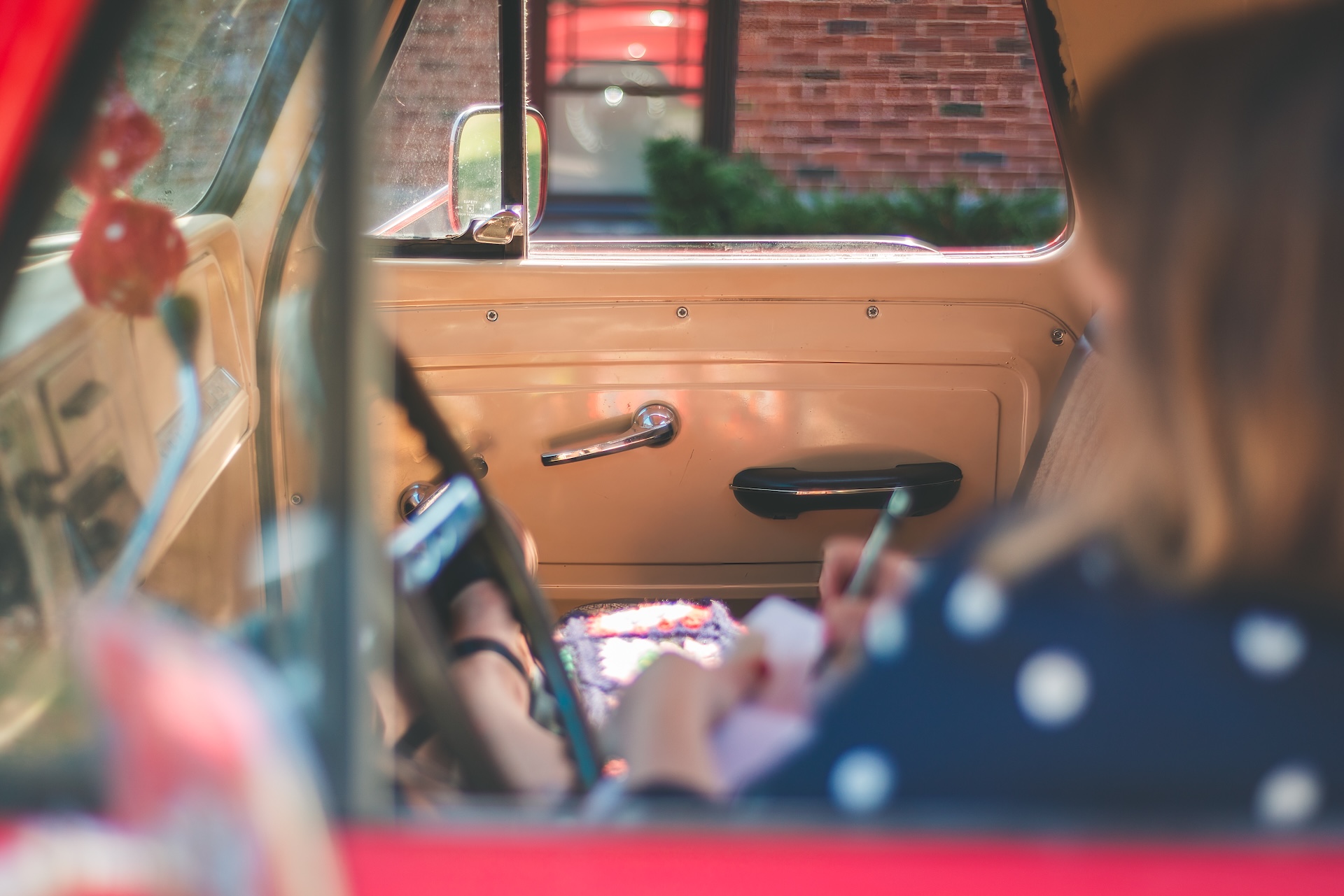 Michigan muralist Jamie posing drawing inside her vintage 1964 Chevy truck during a UP lifestyle branding photoshoot