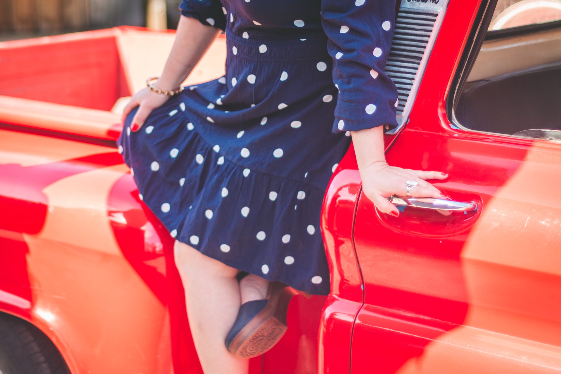 Michigan muralist Jamie posing sitting on her vintage 1964 Chevy truck during a UP lifestyle branding photoshoot