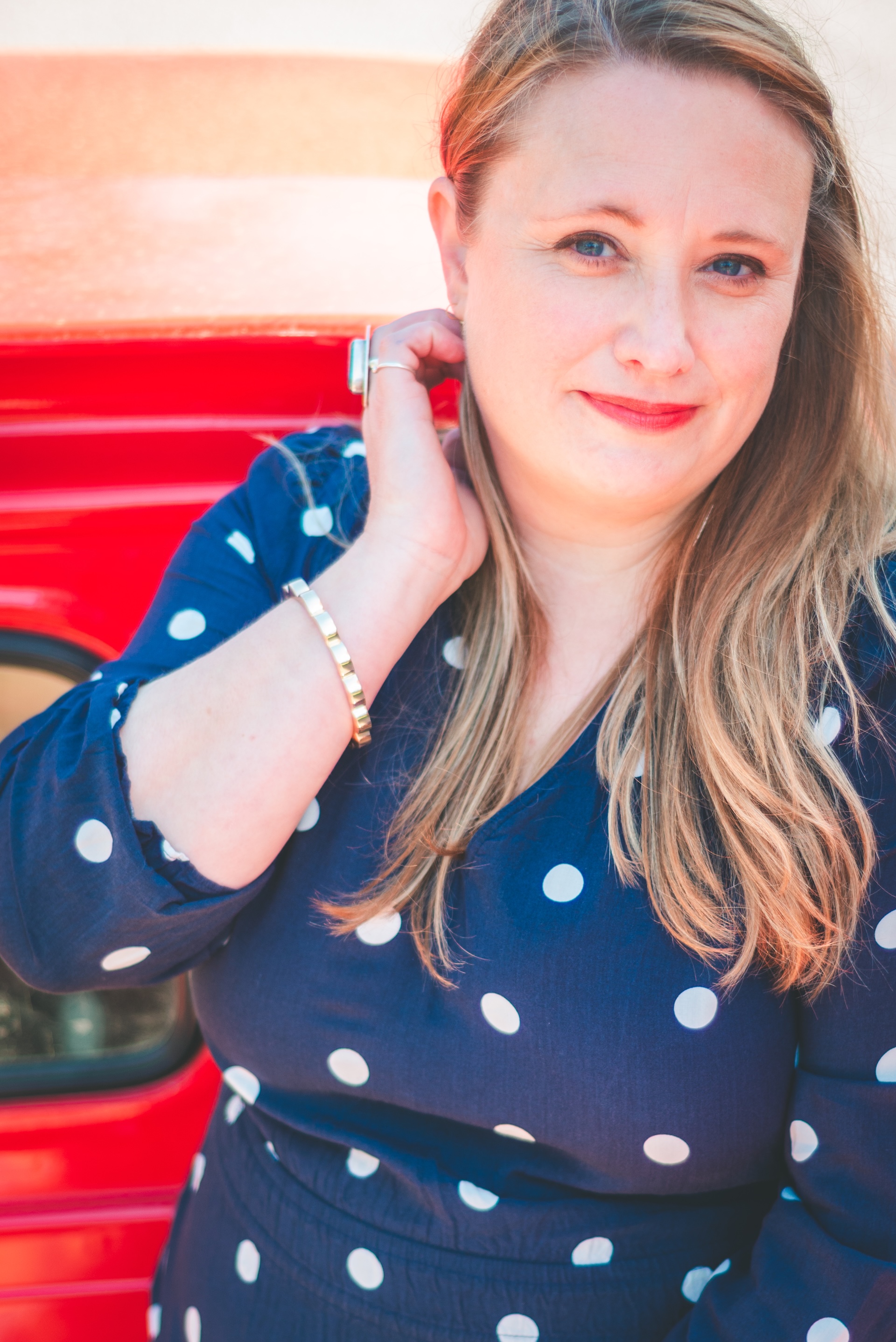 Headshot of Michigan muralist Jamie posing with her vintage 1964 Chevy truck during a UP lifestyle branding photoshoot