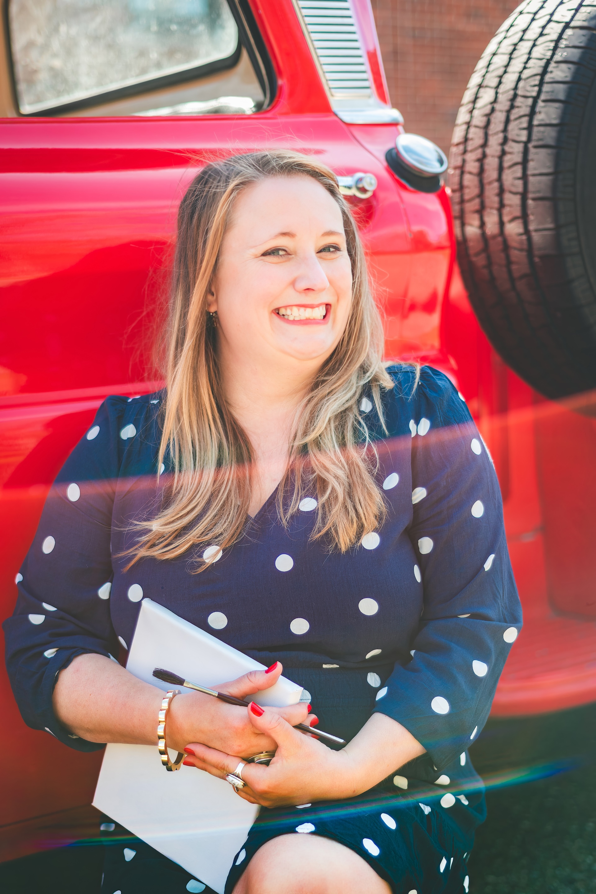 Michigan muralist Jamie posing with her vintage 1964 Chevy truck during a UP lifestyle branding photoshoot