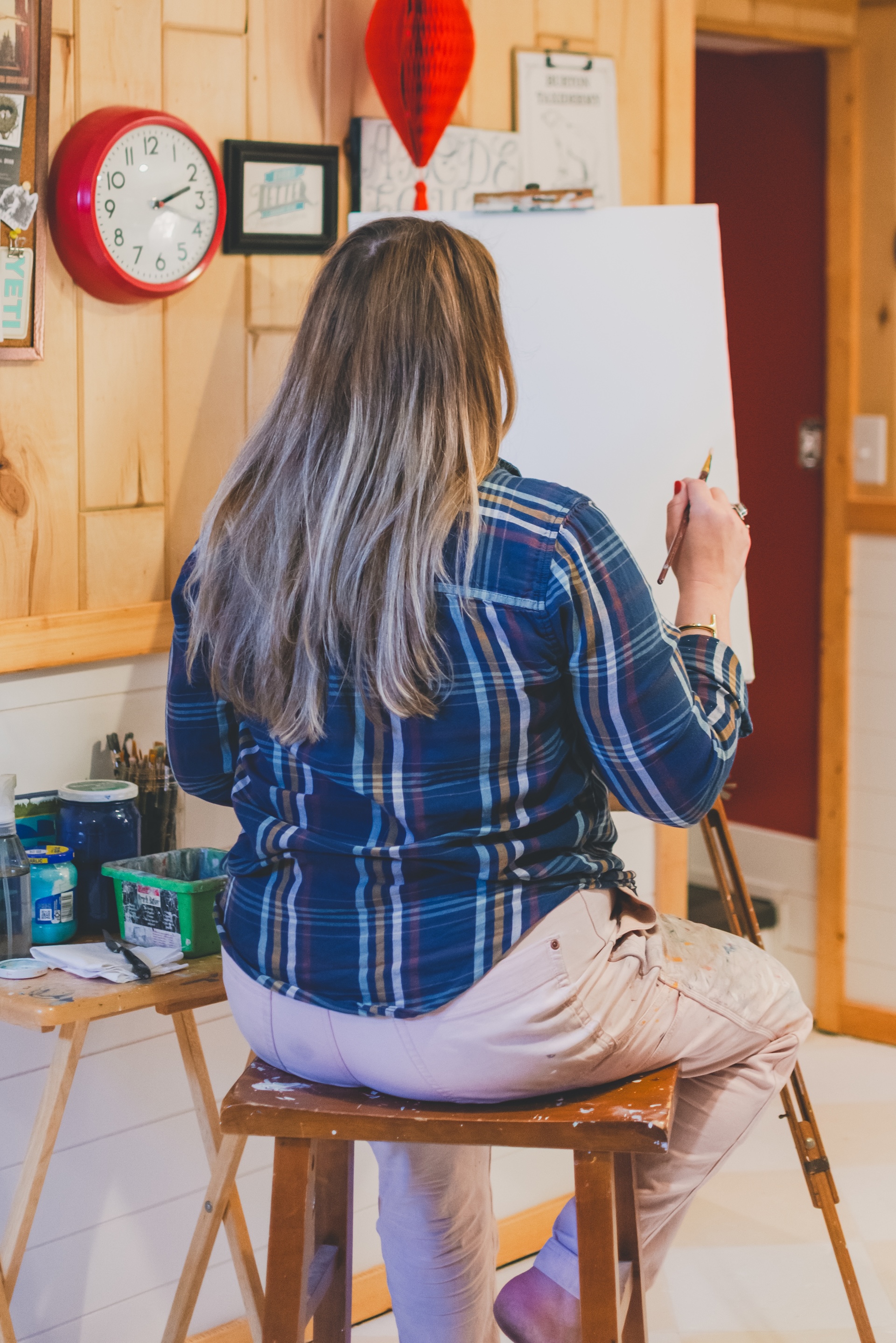 Jamie of Starsiding Studio painting custom vintage works in her Munising MI art studio