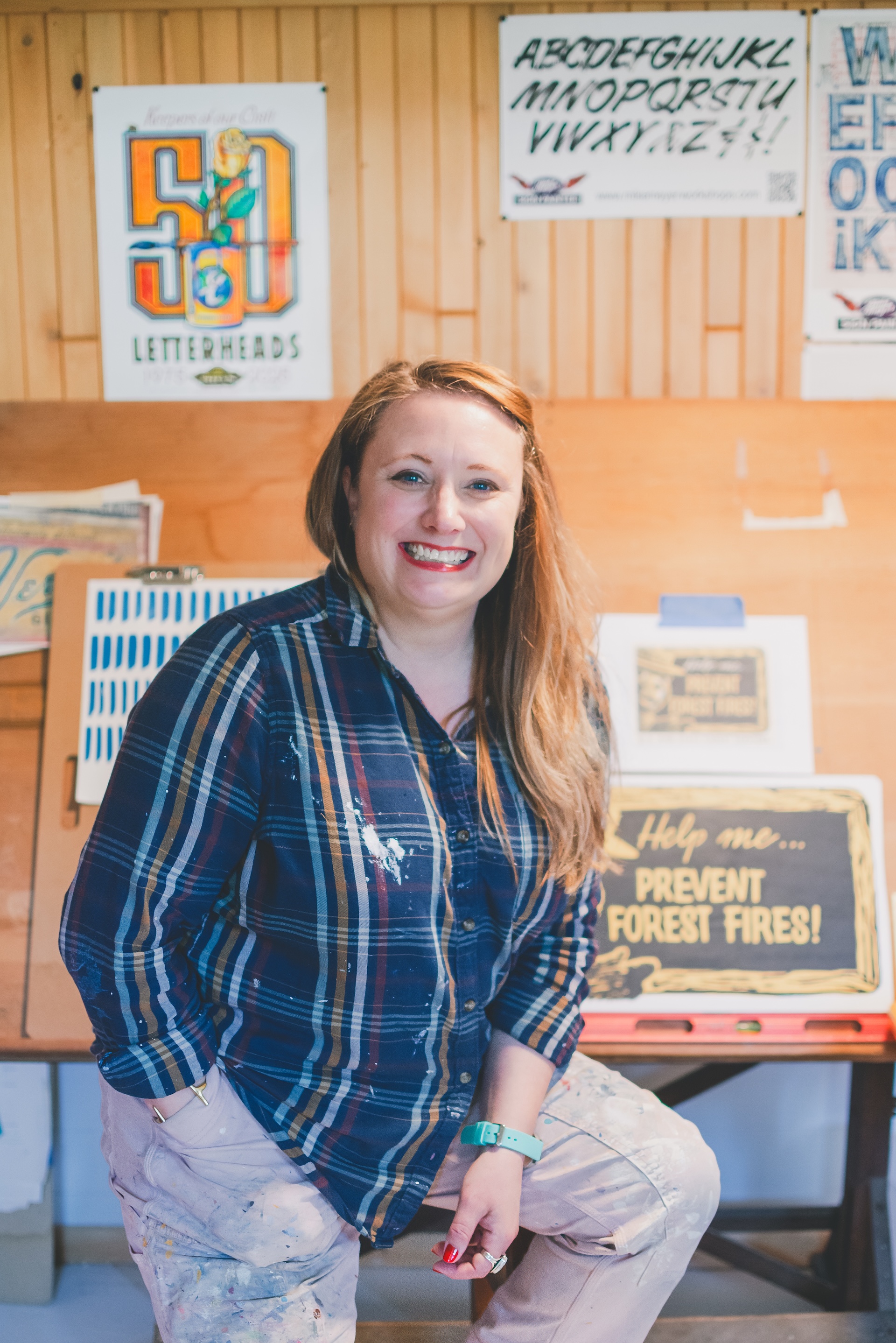 Jamie of Starsiding Studio painting custom vintage works in her Munising MI art studio